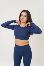 NOVUS long sleeve athletic crop top in navy blue, featuring a crew neckline and soft moisture-wicking fabric.